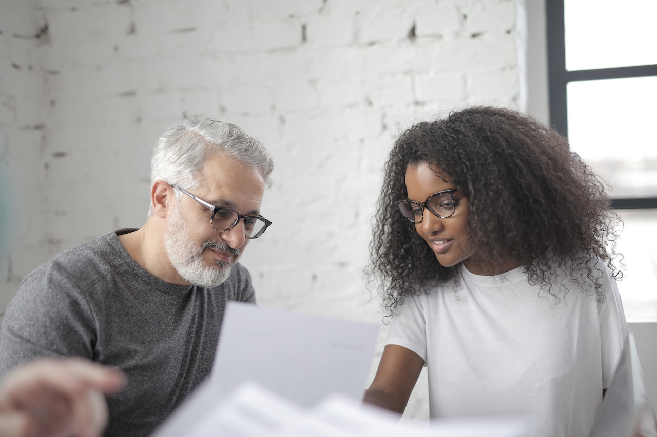 Man discussing business strategy with female employee in an office