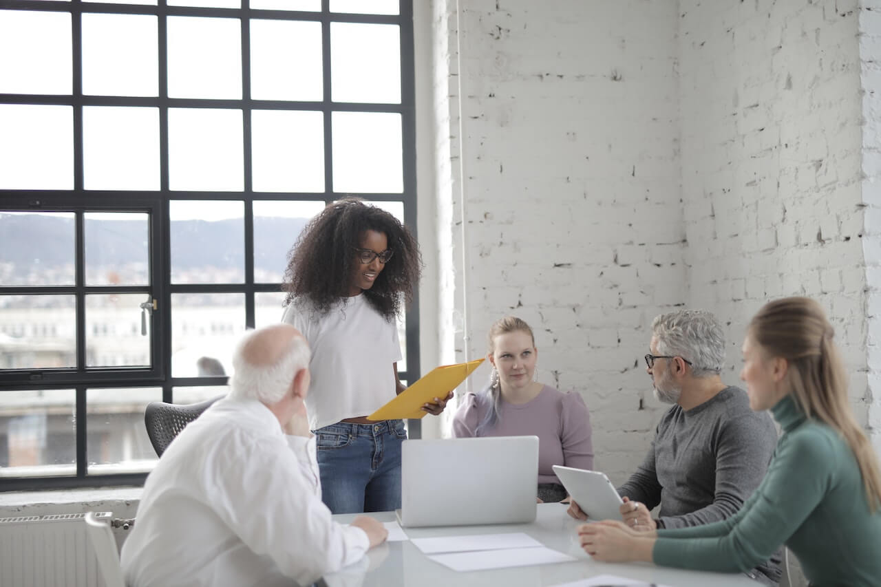 Smiling woman explaining project to colleague