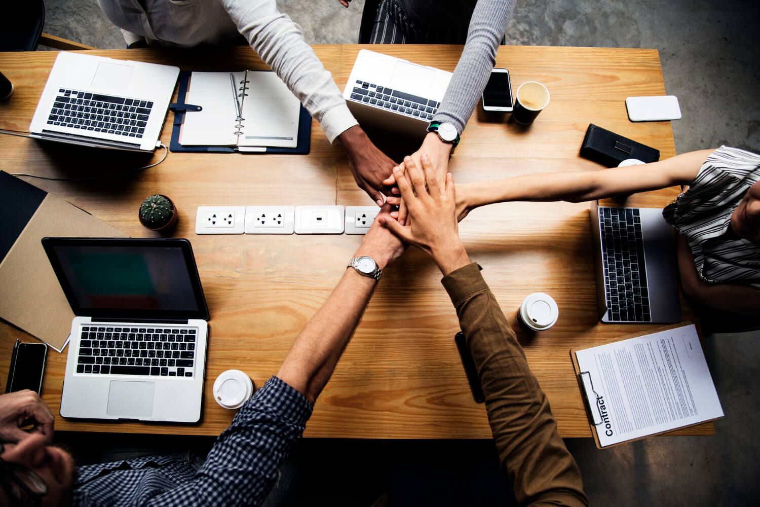 Team of-business-people-stacking-hands