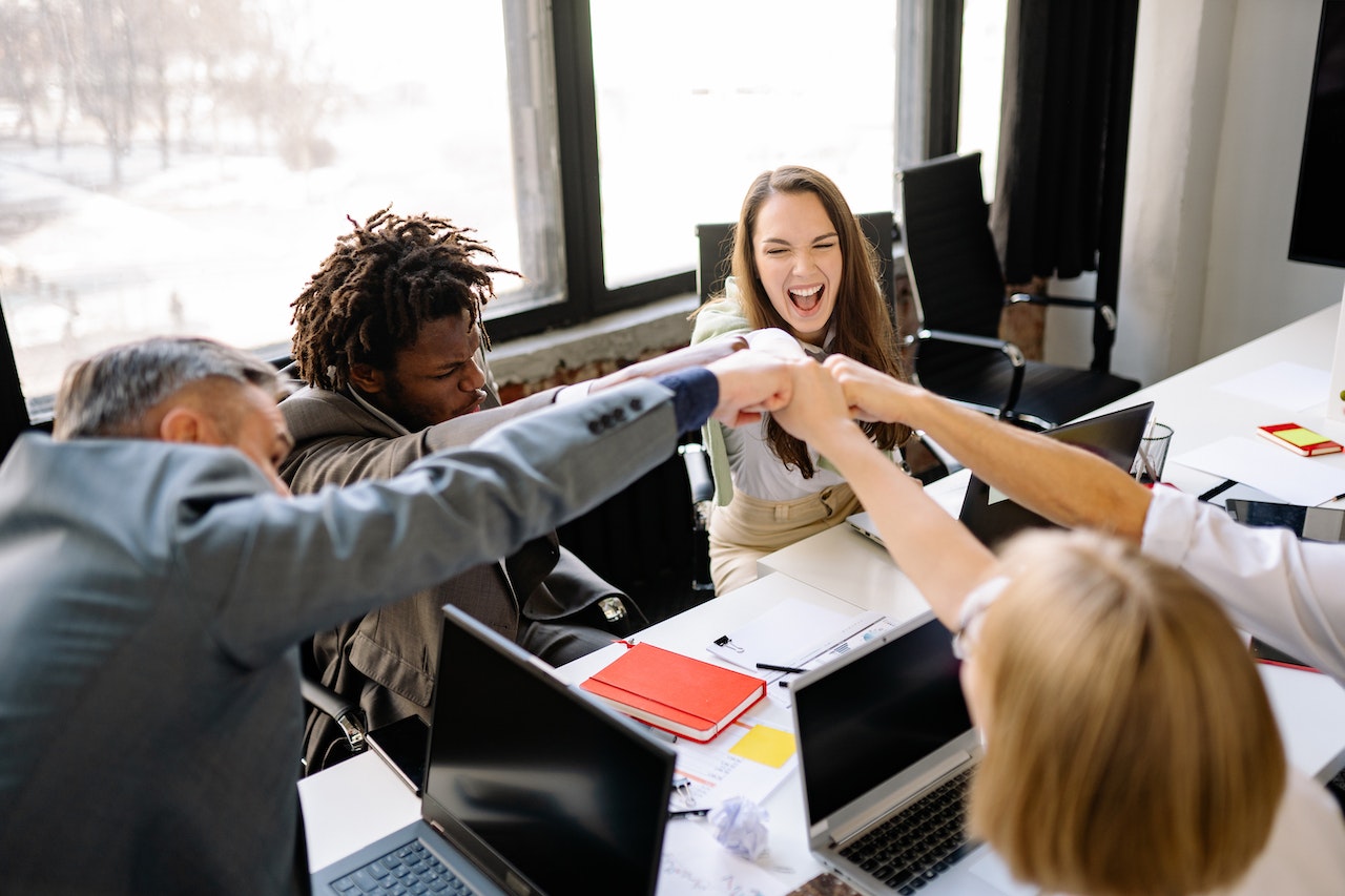 Triumphant Colleagues doing a Fist Bump