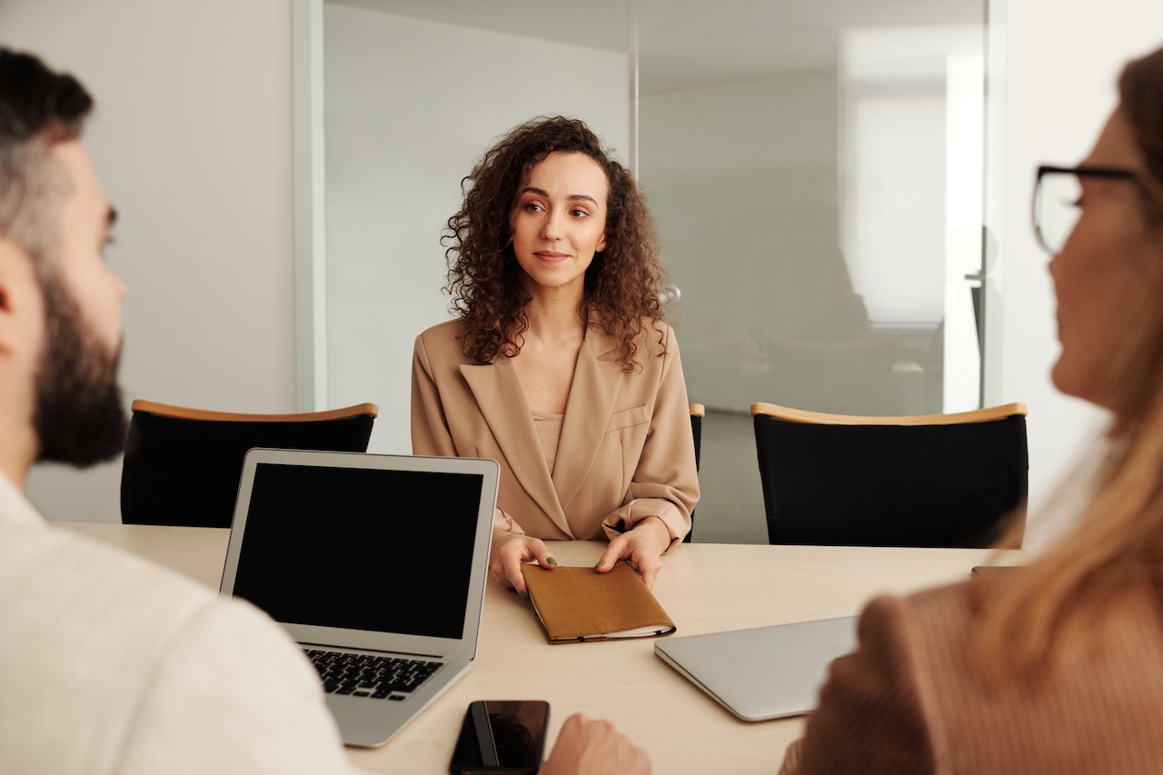 Woman in brown sleeve in an interview