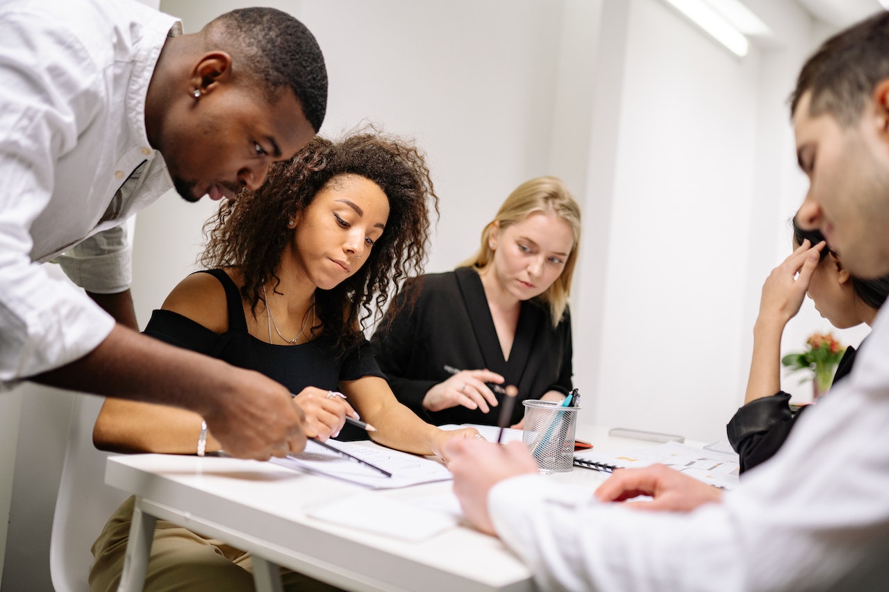 Young man supervising a lady in an office