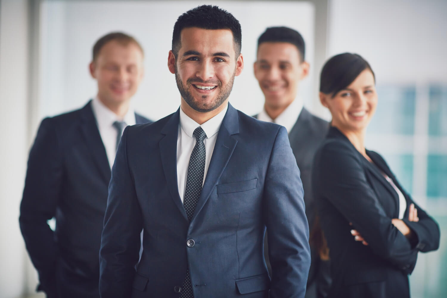 Group of business team standing behind their team leader