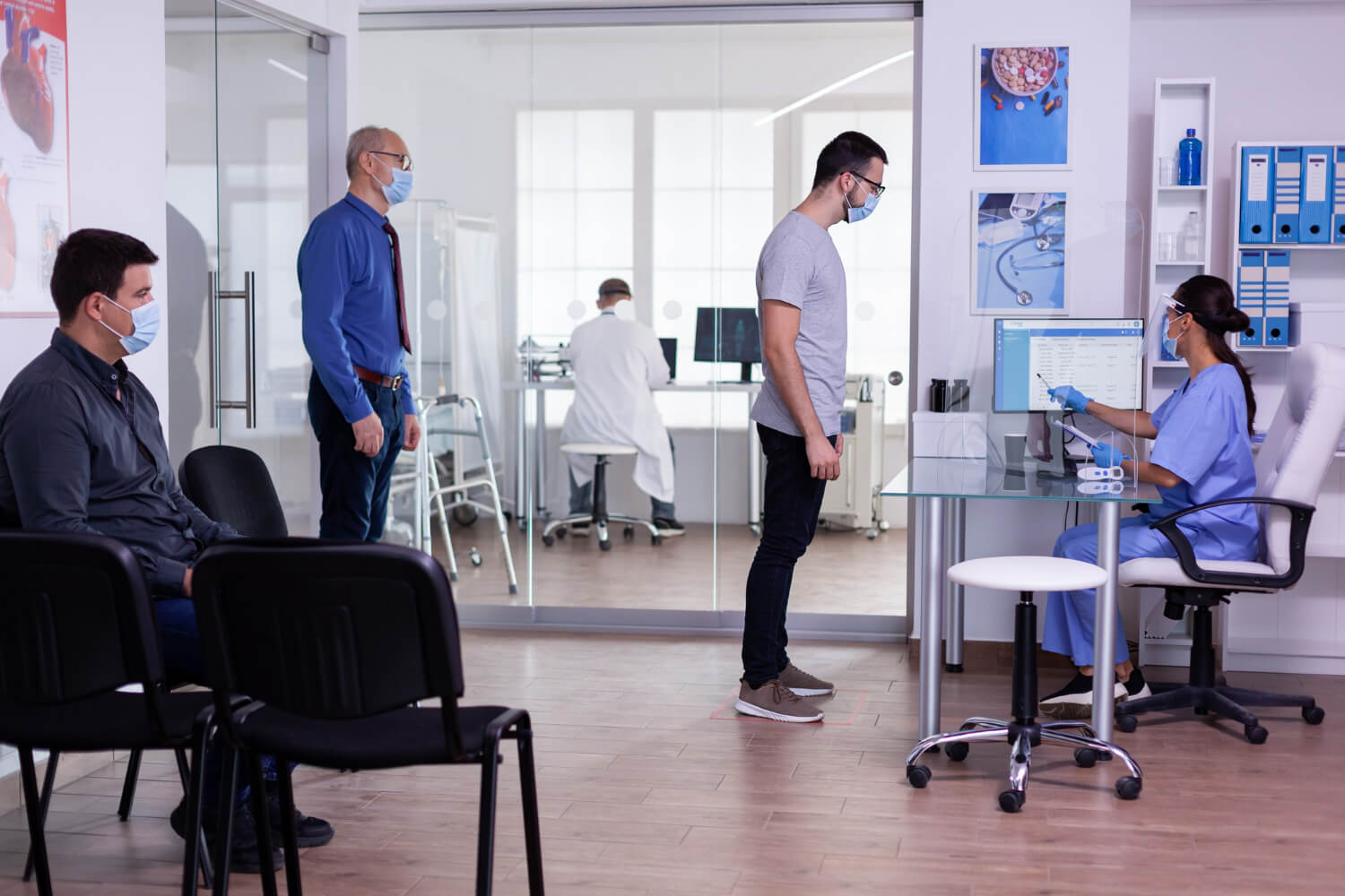 men-on-a-queue-to-meet-with-the-hospital-receptionist