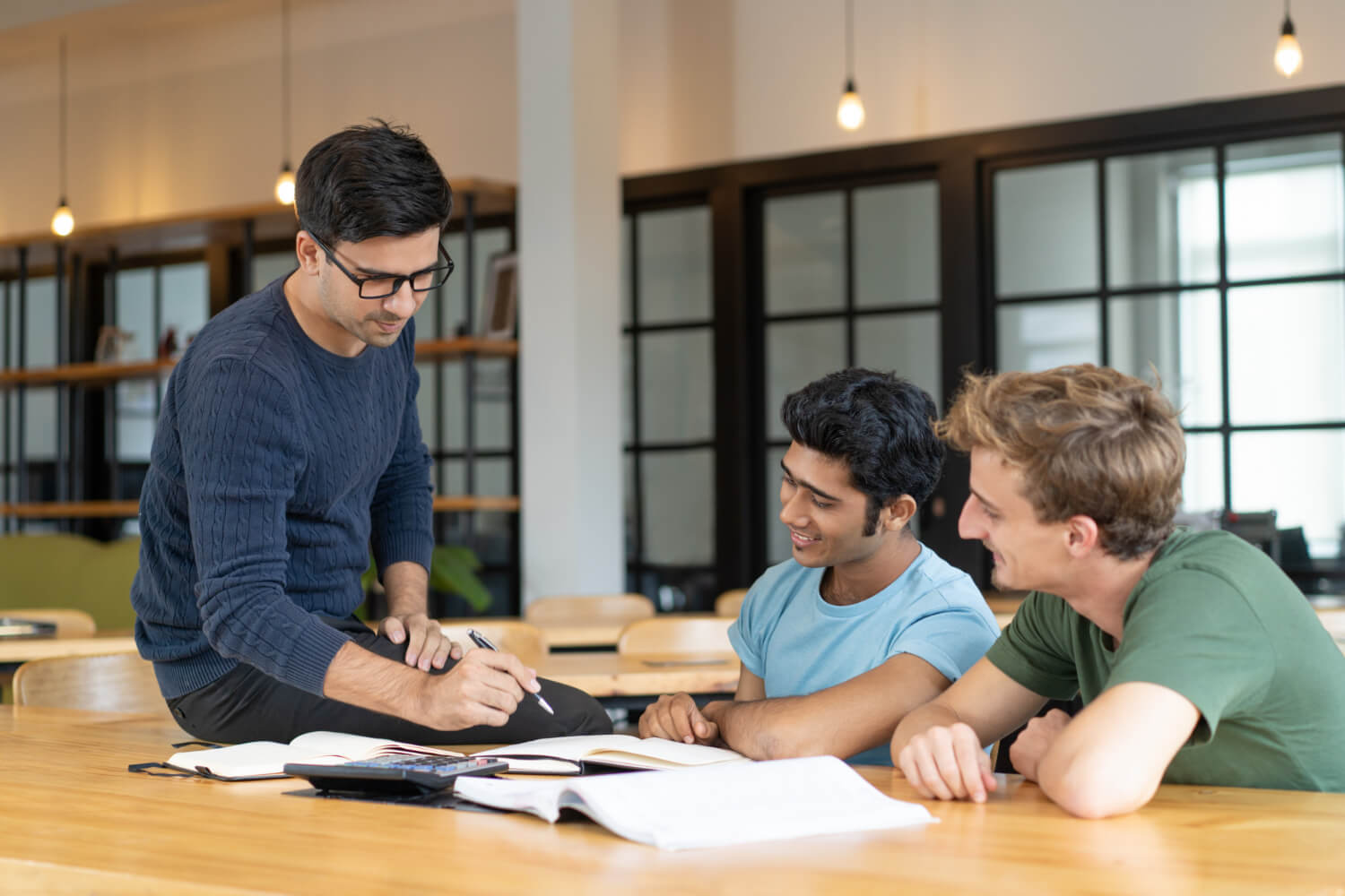 serious-teacher-checking-assignment-two-students