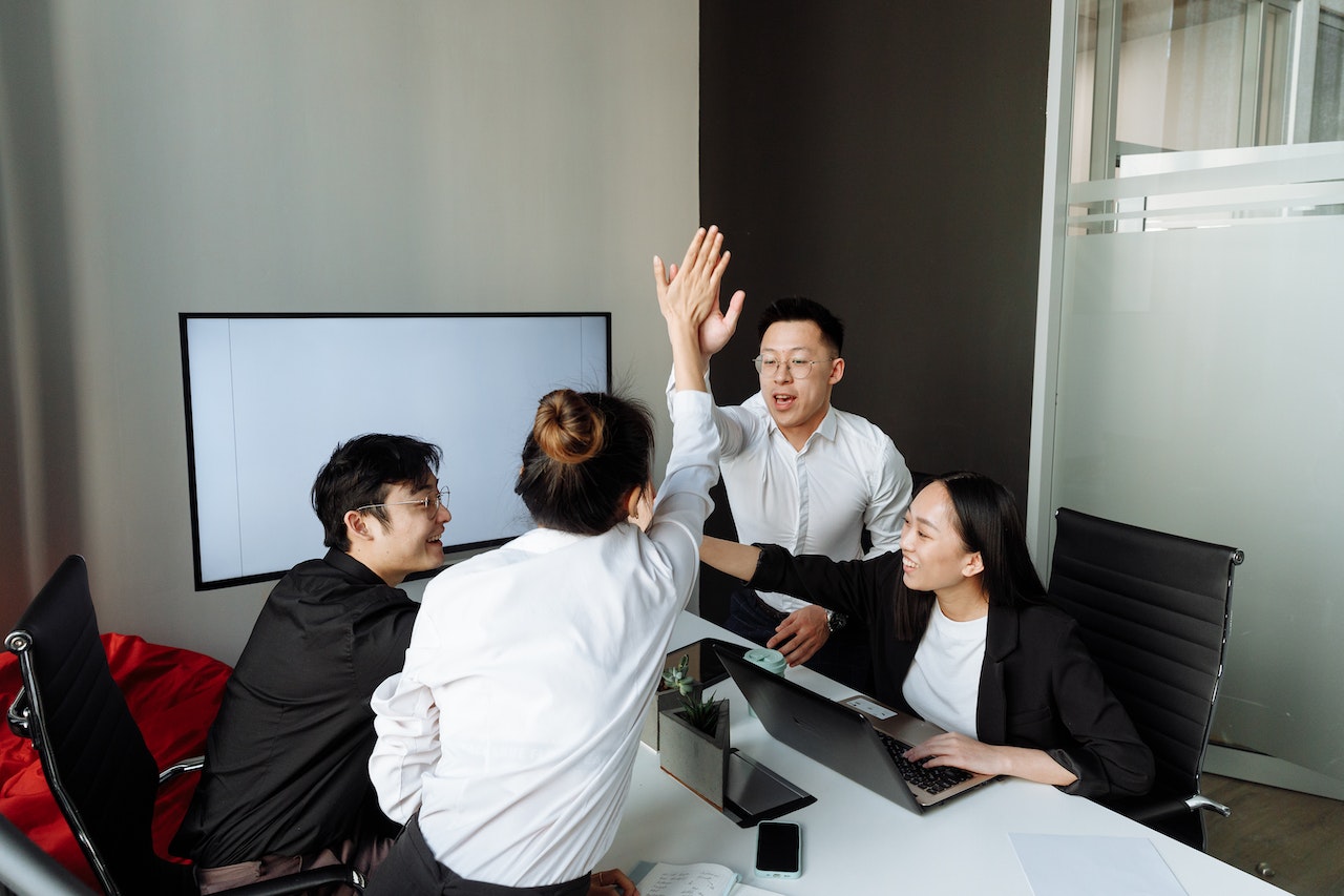 A Group of People Having a Meeting in the Office While Shaking Hands