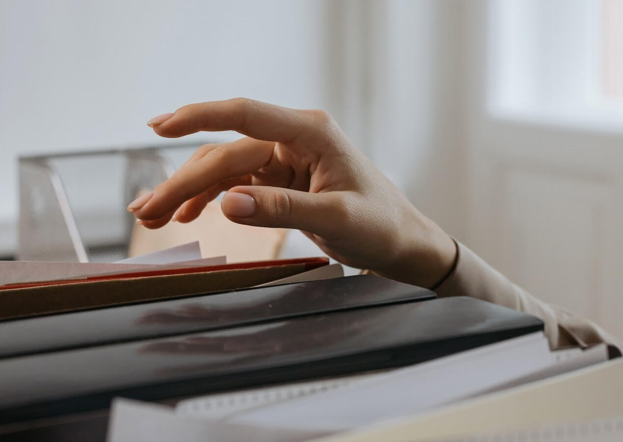 A Person Reaching Out for a File