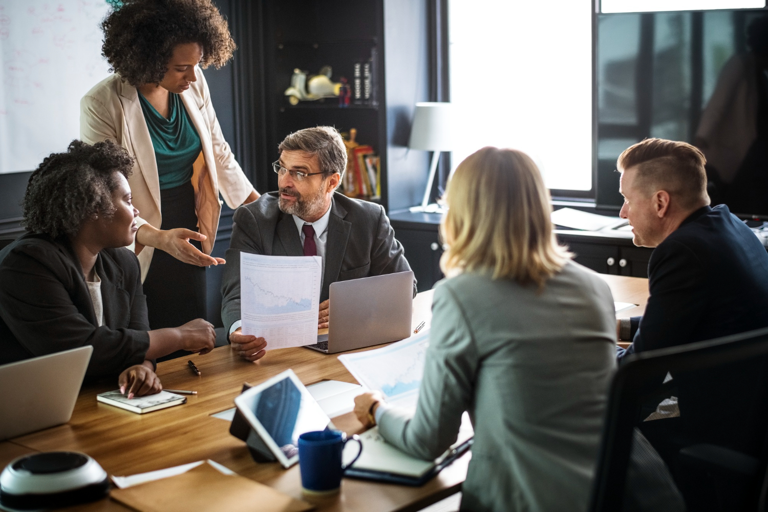 A-female-manager-representing-her-team-in-a-management-meeting