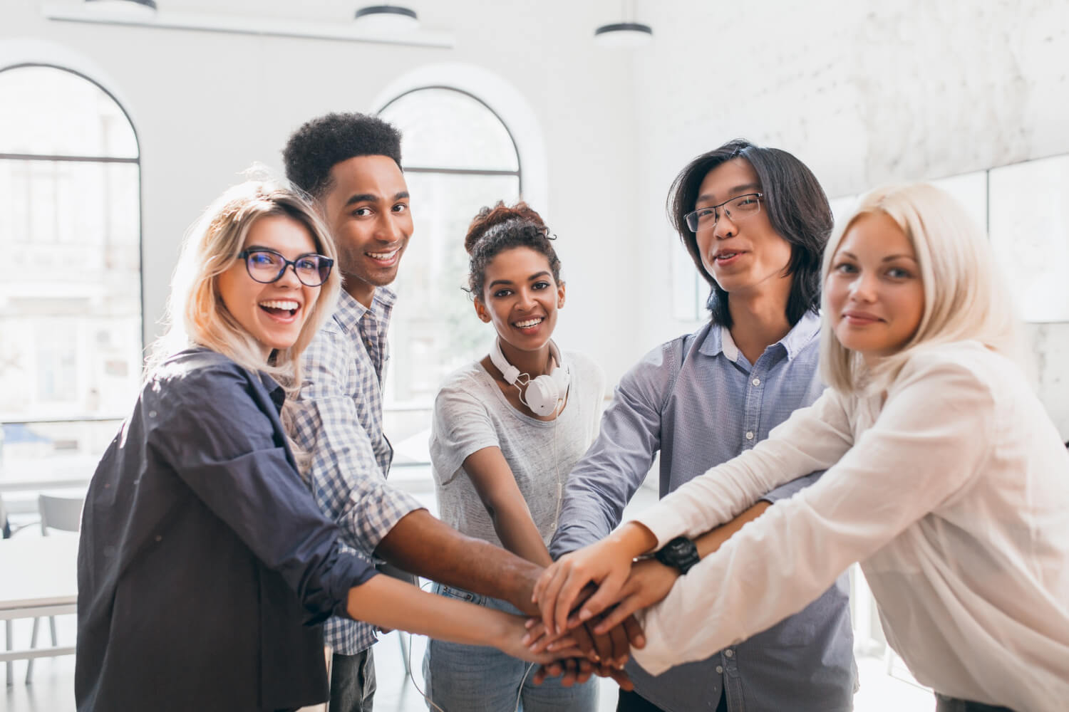 An-office-team-rejoicing-and-holding-hand-together