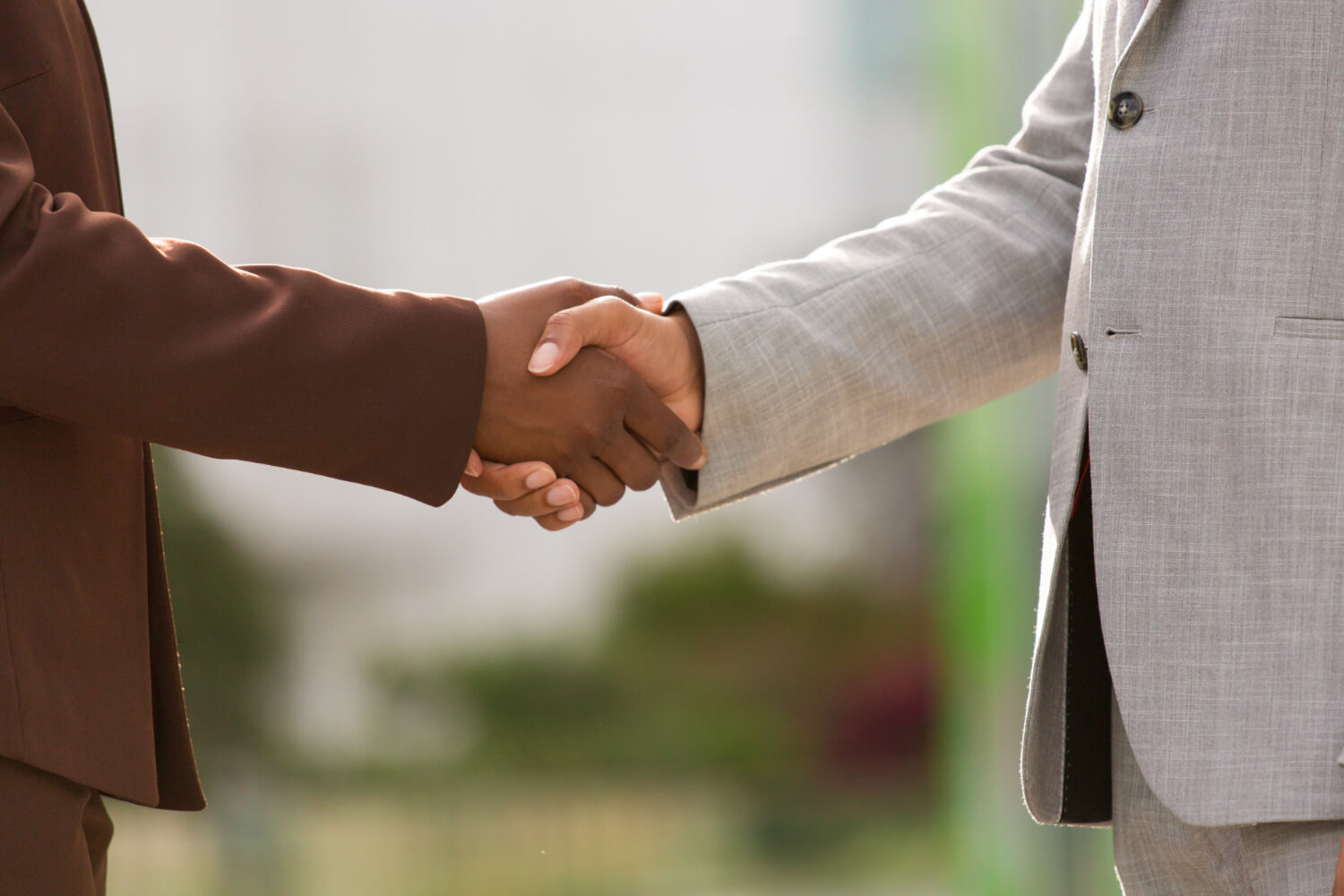 Business men on suit having a handshake