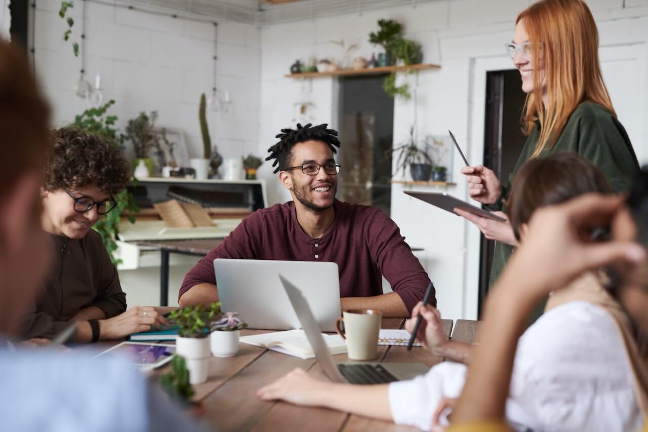 Business people sitting round a desk in a meeting