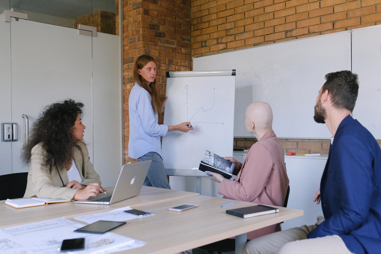 Concentrated coworkers sitting on seminar in modern workspace