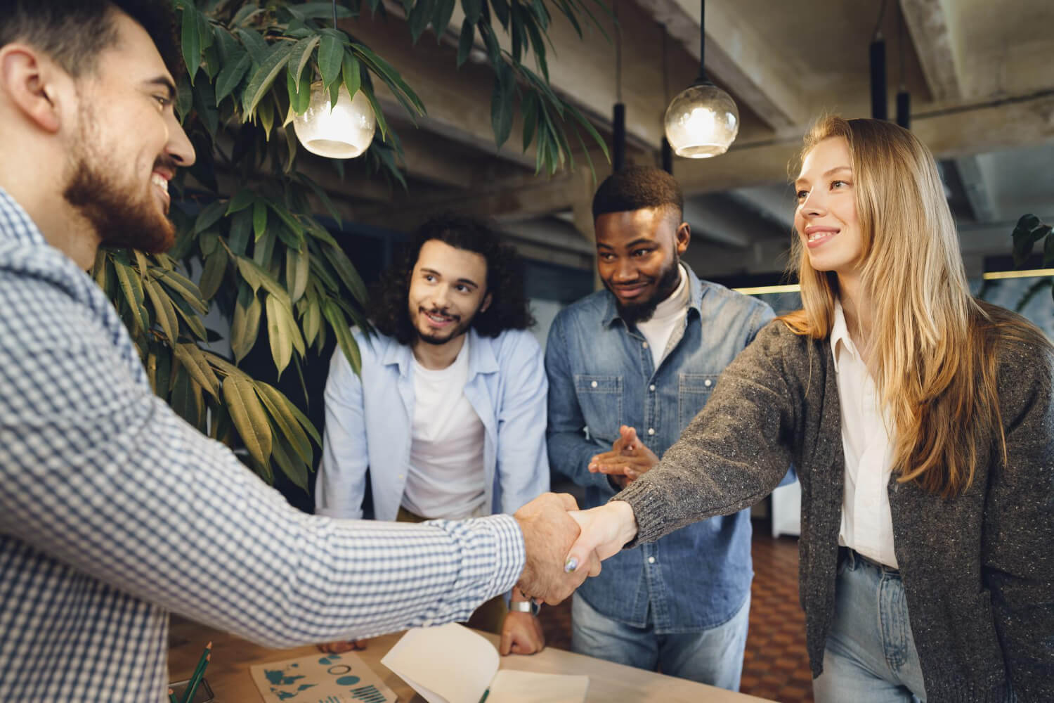 Female office executive shaking hand with employee