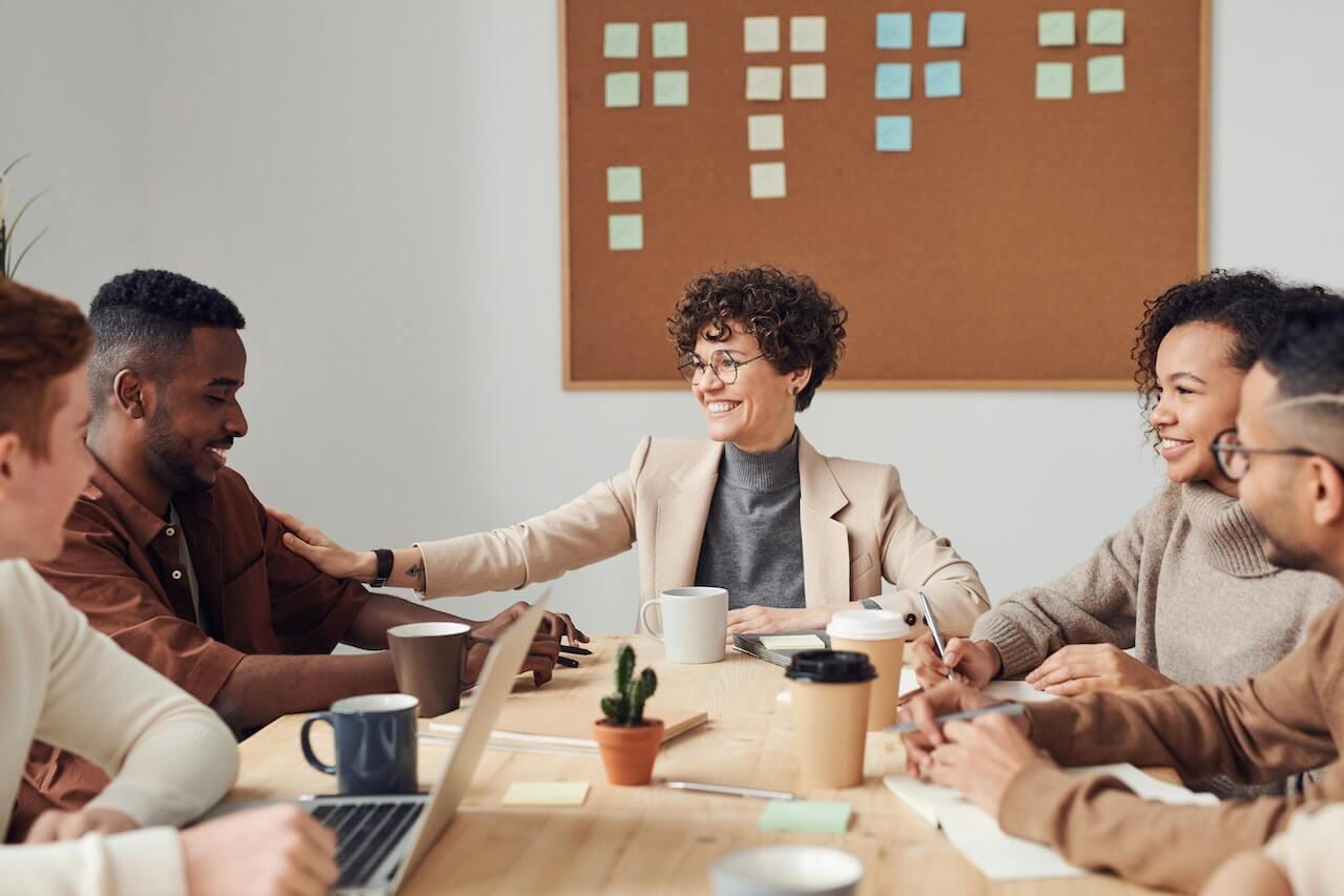 Happy Colleagues Communicating While Working Together