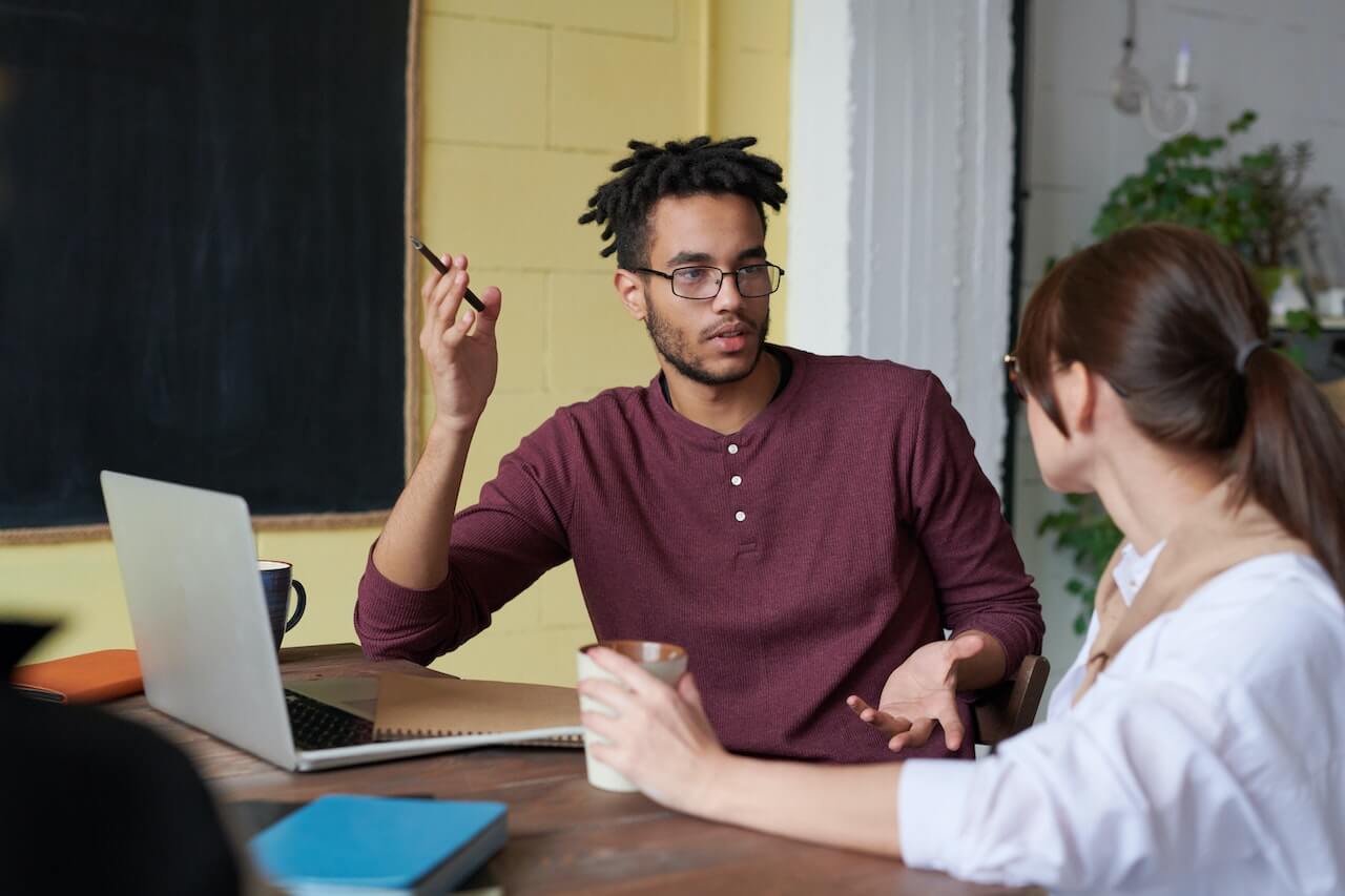 Man Holding Pen in a Meeting