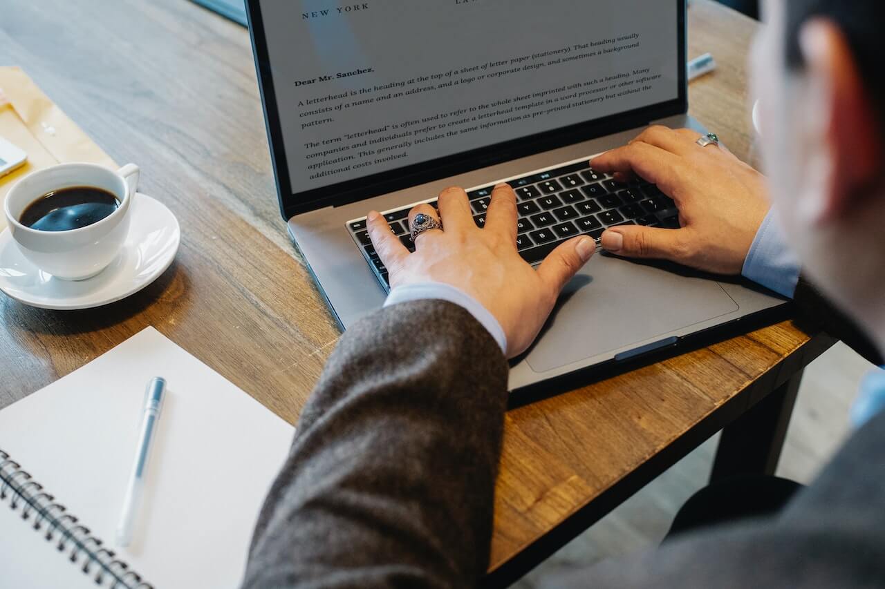 Man typing on laptop in office