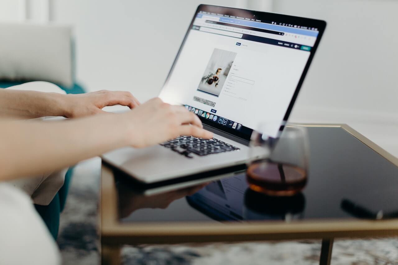 Person using a laptop placed on the desk