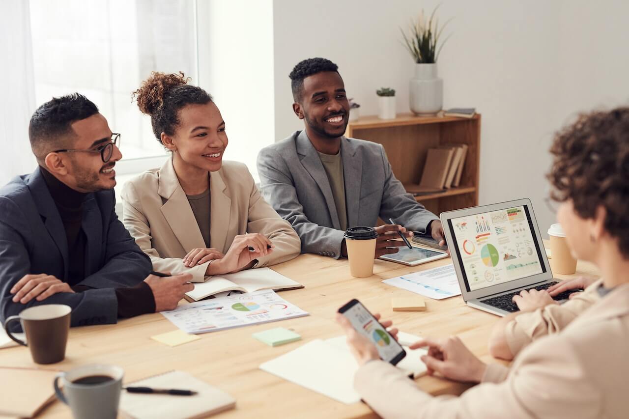 Smiling business people chatting together