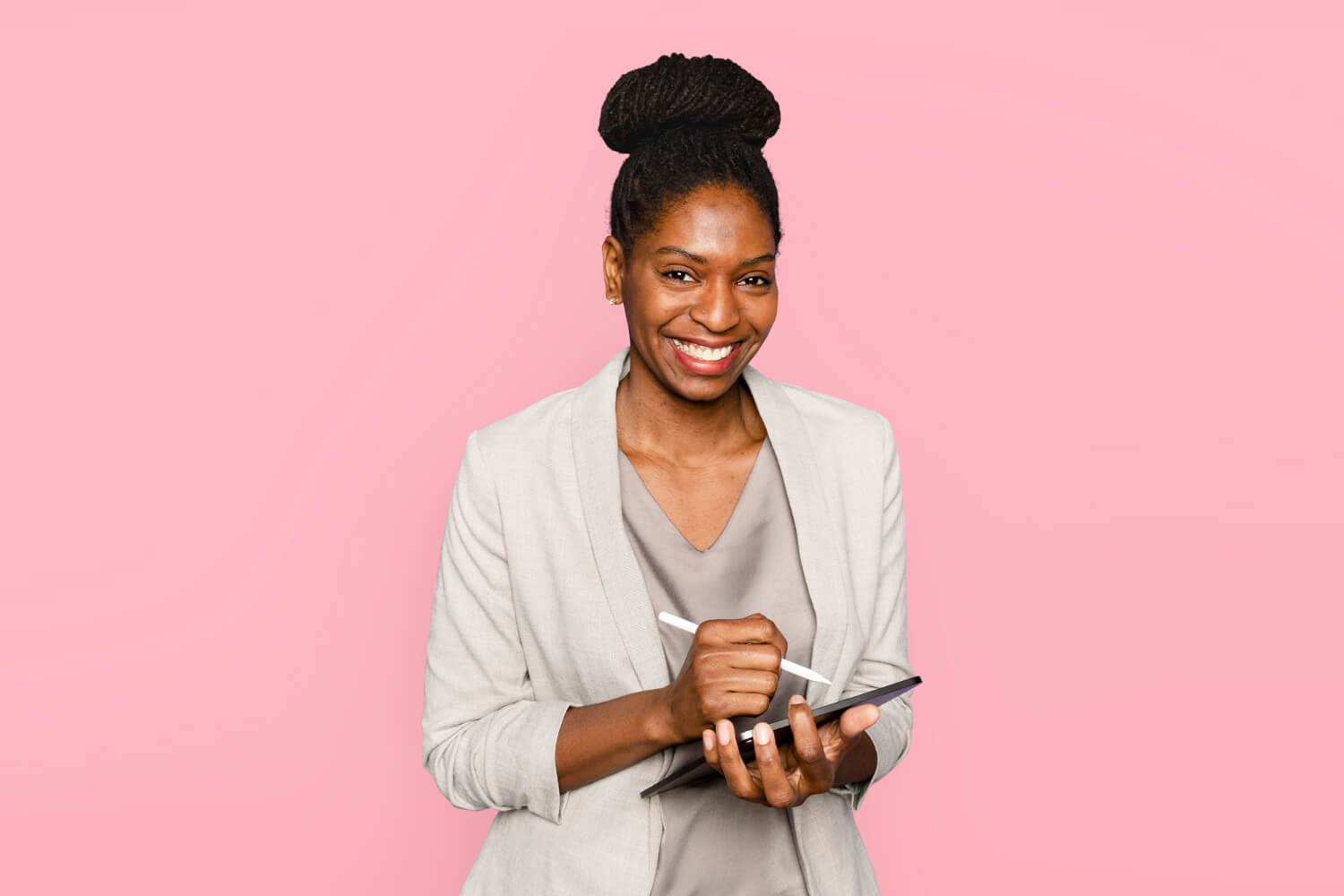 Smiling-woman-writing-notes on-tablet-digital-device