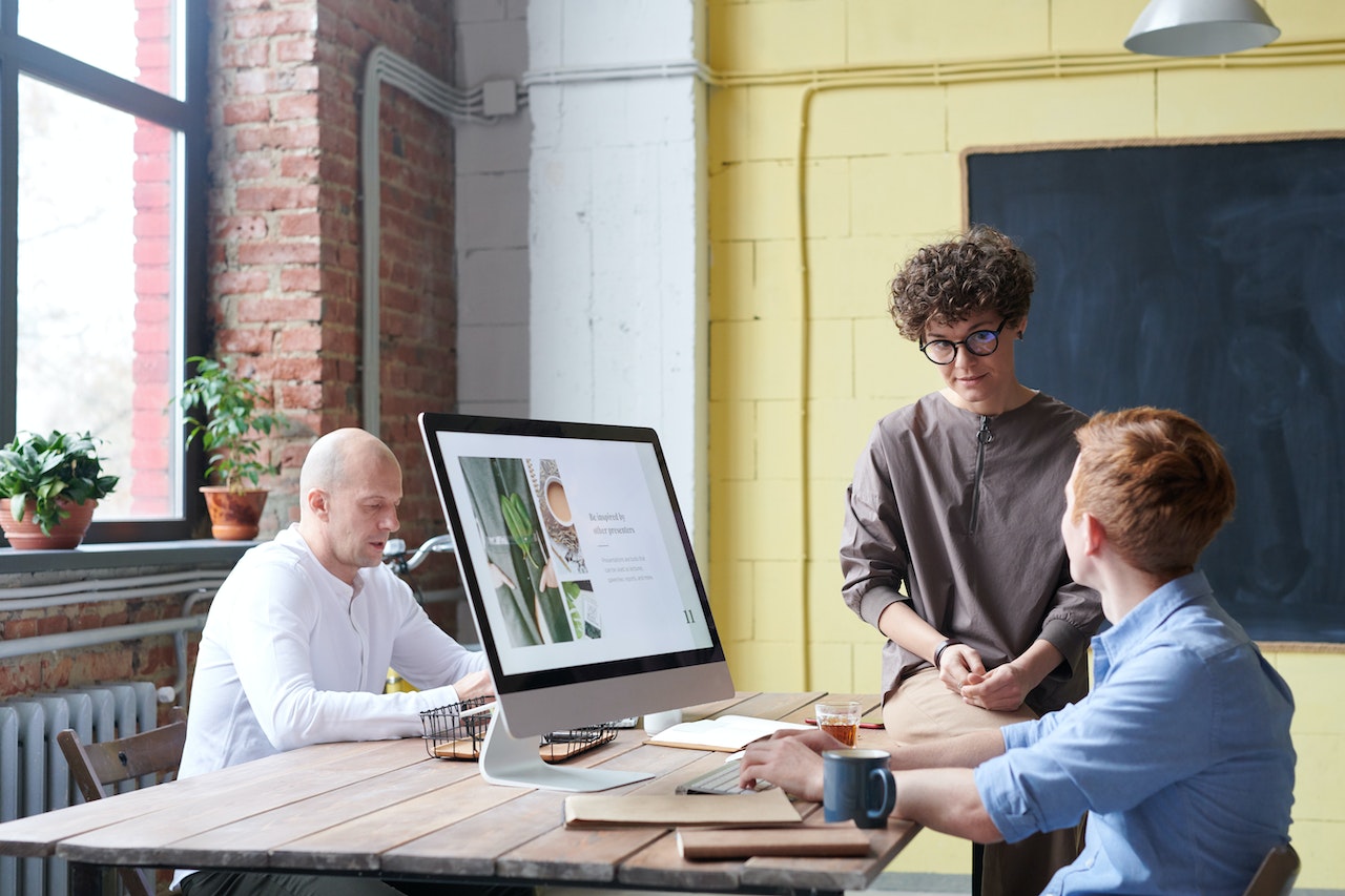 Woman Sitting On Wooden Table in a Meeting