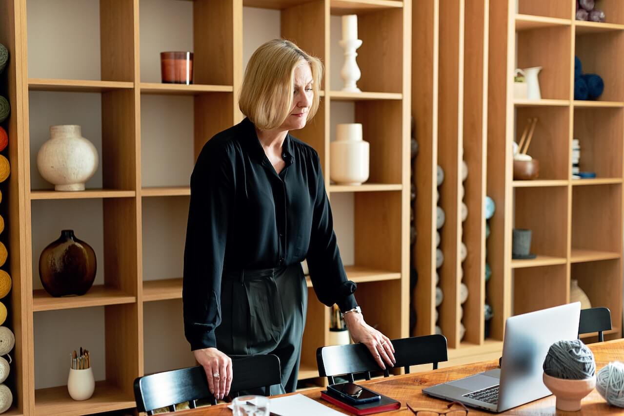 Woman Standing in Front of a Laptop