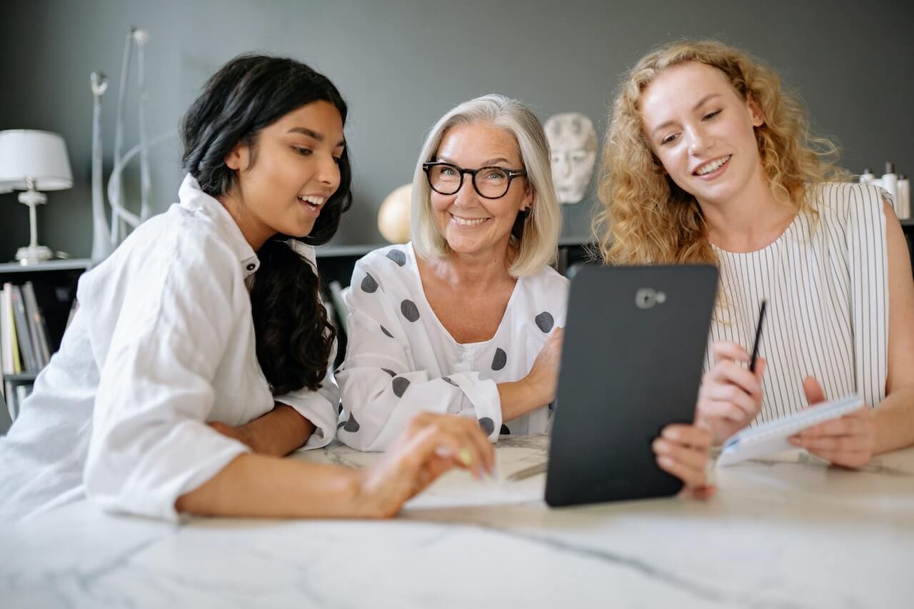 Women Having a Meeting While Smiling