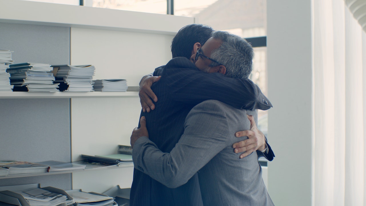 colleagues-hugging-each-other-after-reconciling