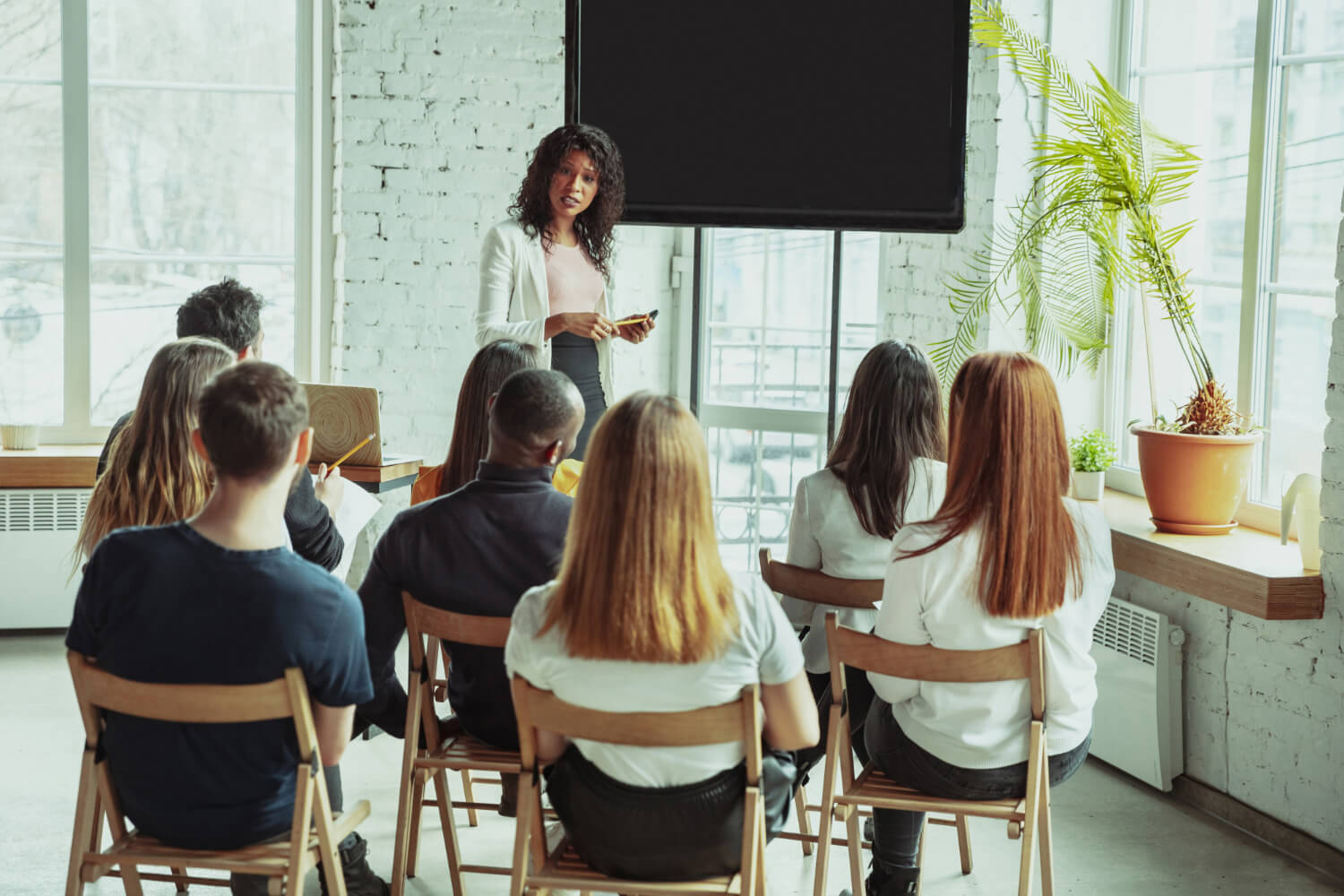 female-african-american-speaker-giving-presentation-hall-university-workshop