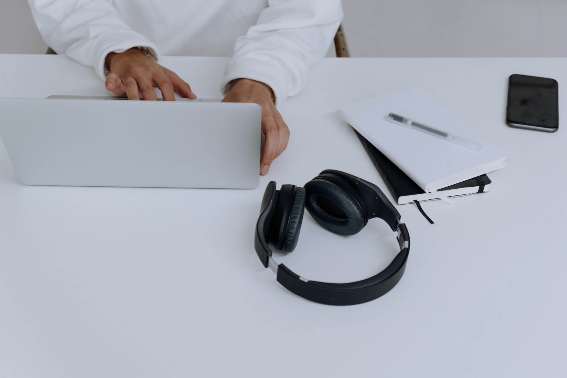 Person in White Dress Shirt Using Macbook to check out an llc operating agreement template