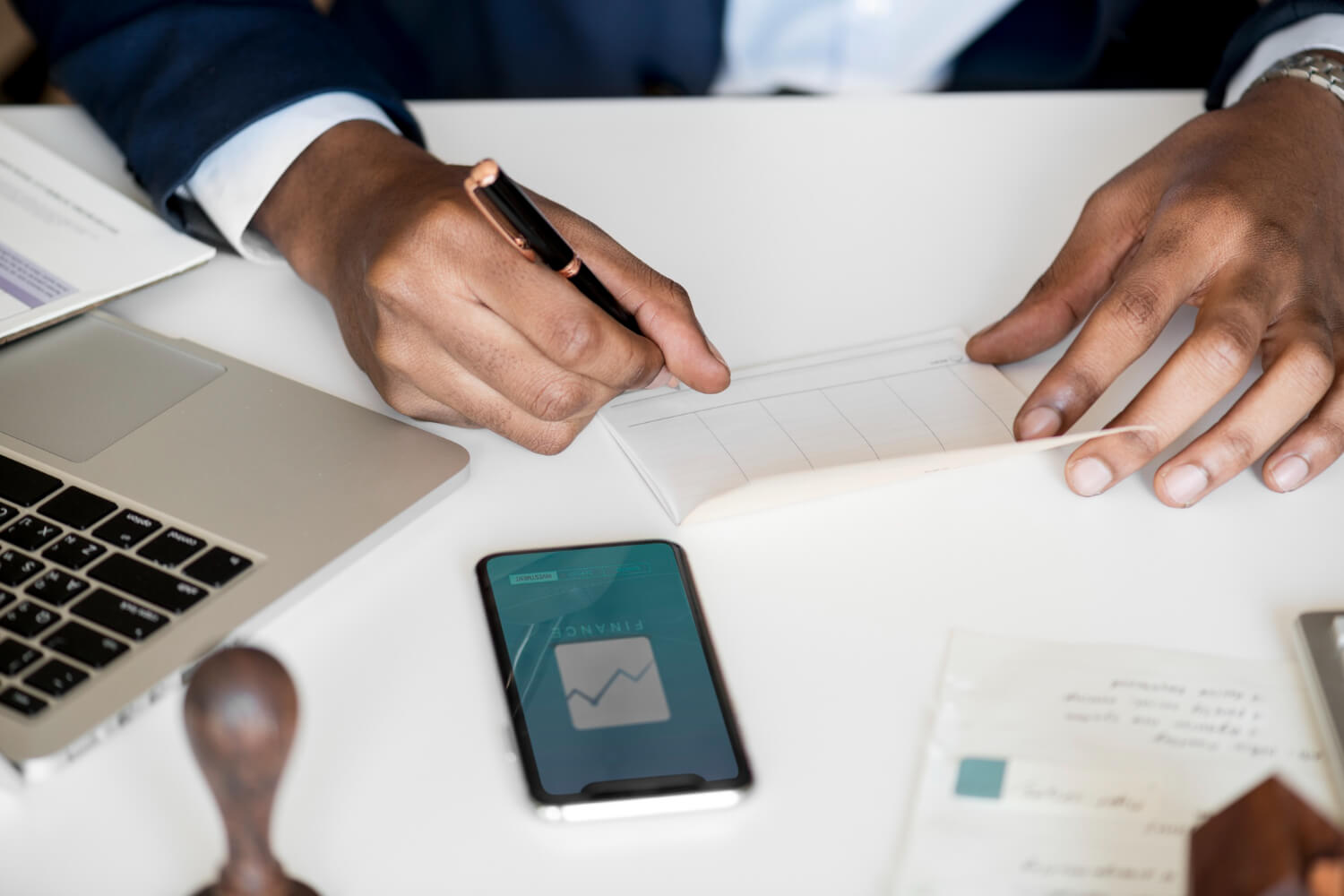 Businessman checking bankbook in his office