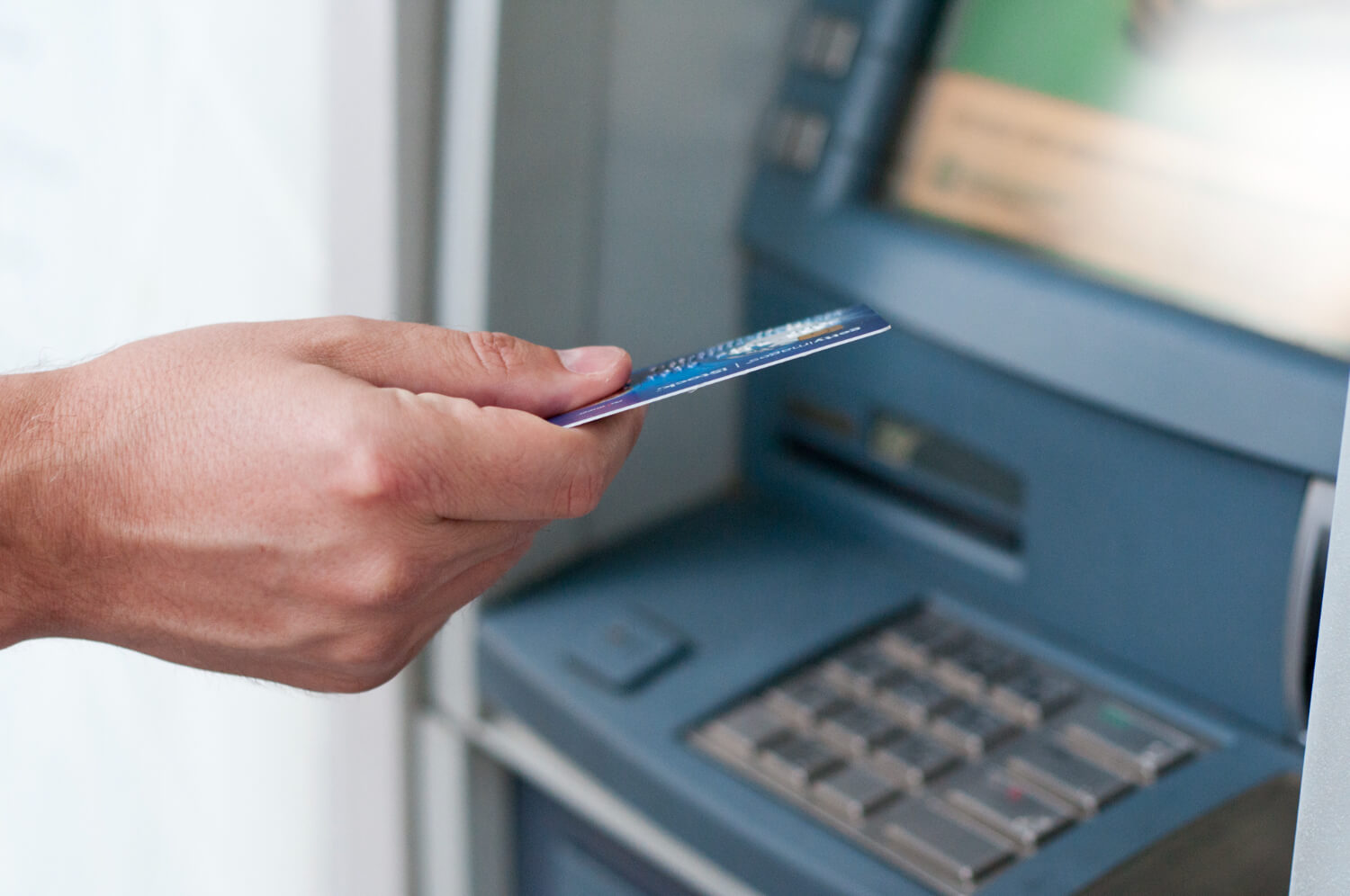 Businessperson performing card transactions on an ATM