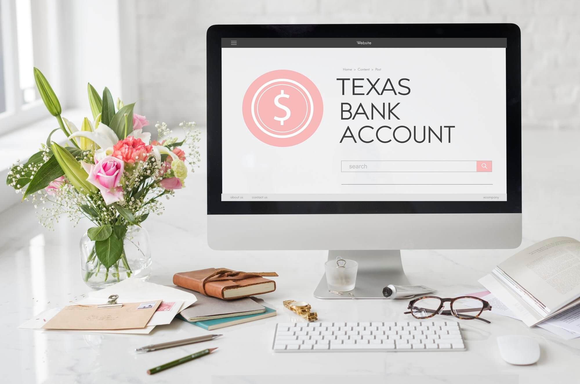 A work desk with a monitor screen displaying the words "Texas bank account"