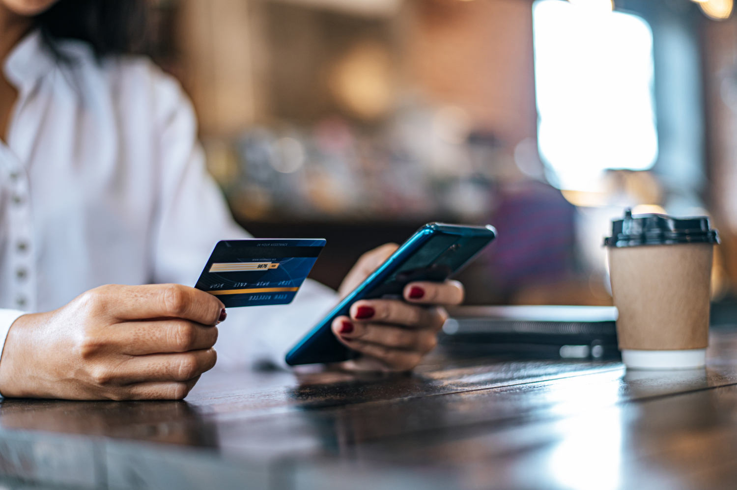 Someone paying for coffee with a credit card