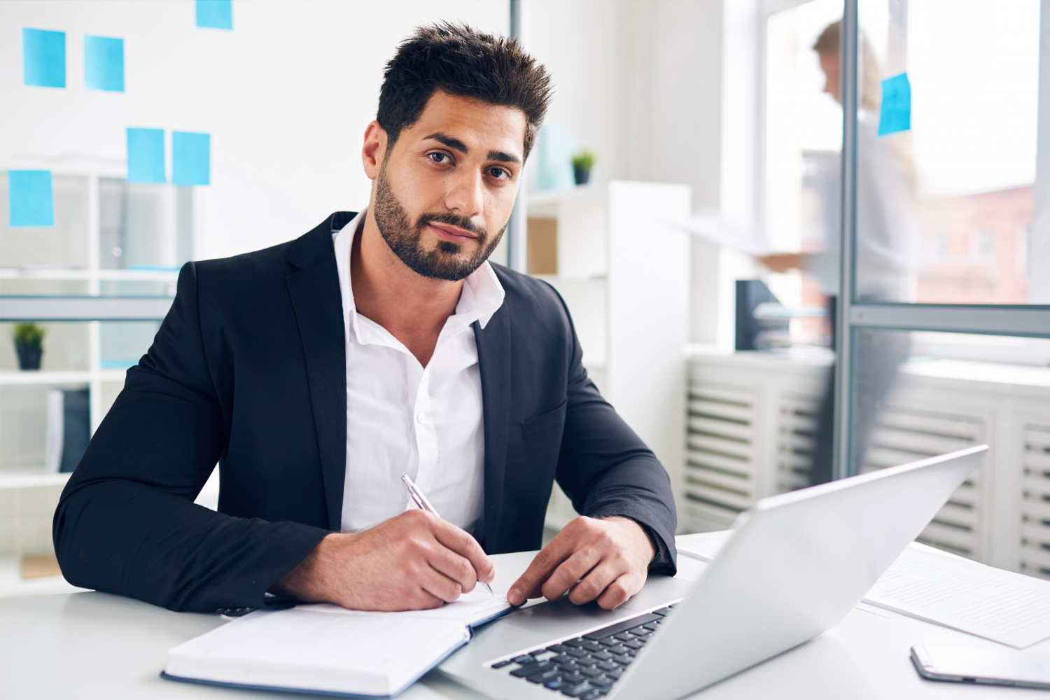 Businessman writing down financial plans