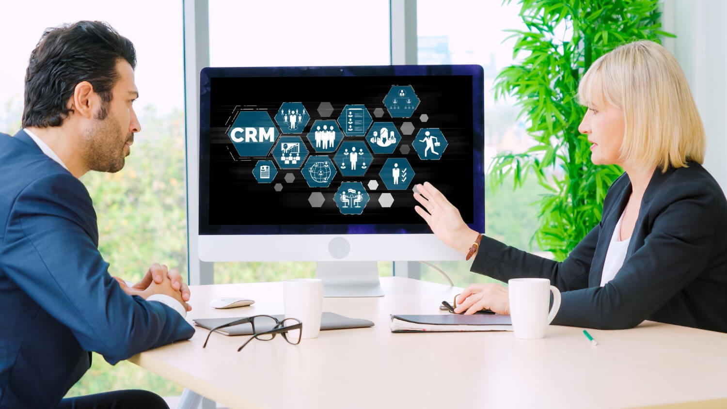 Business people looking at a CRM concept on a computer screen