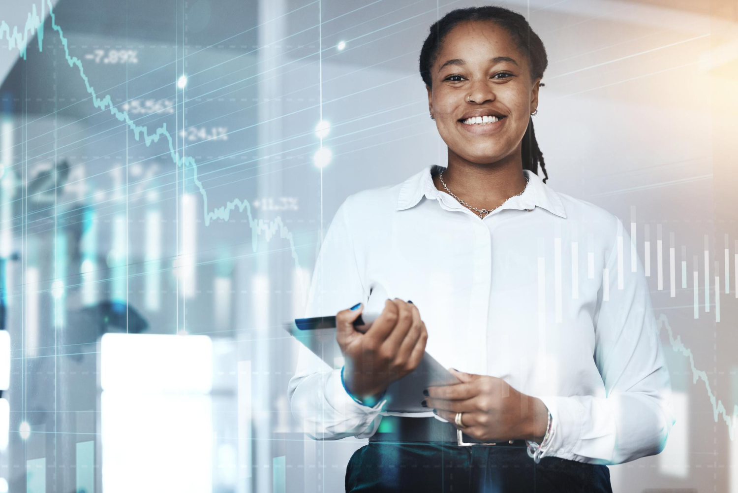 Happy woman holding a tablet with a stock market hologram behind her