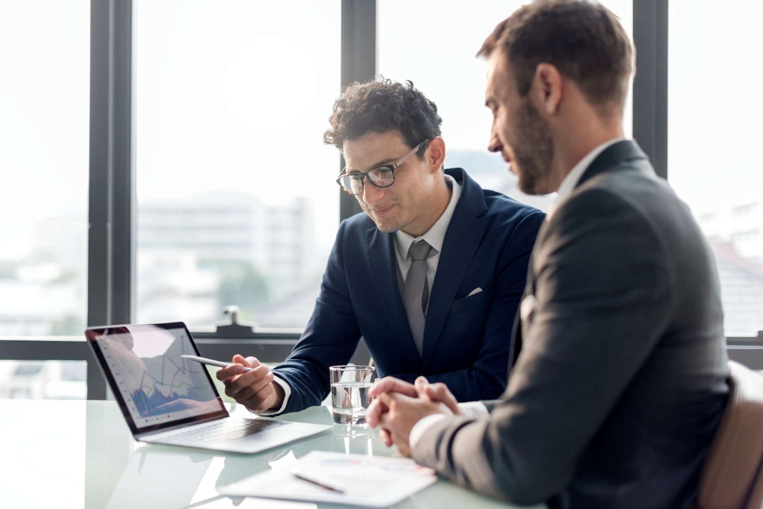 Businessmen looking at a financial graph