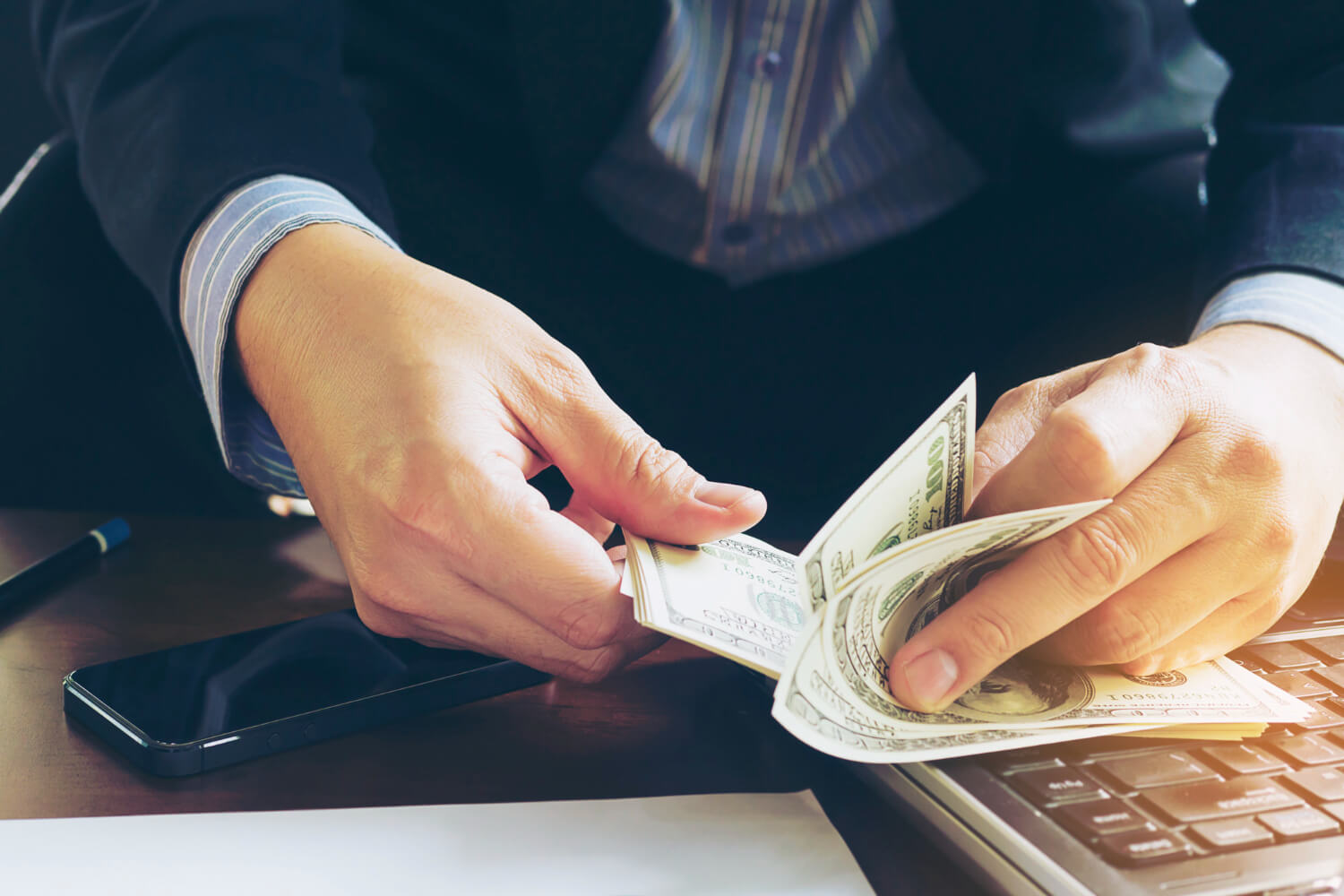 Businessman counting dollar notes