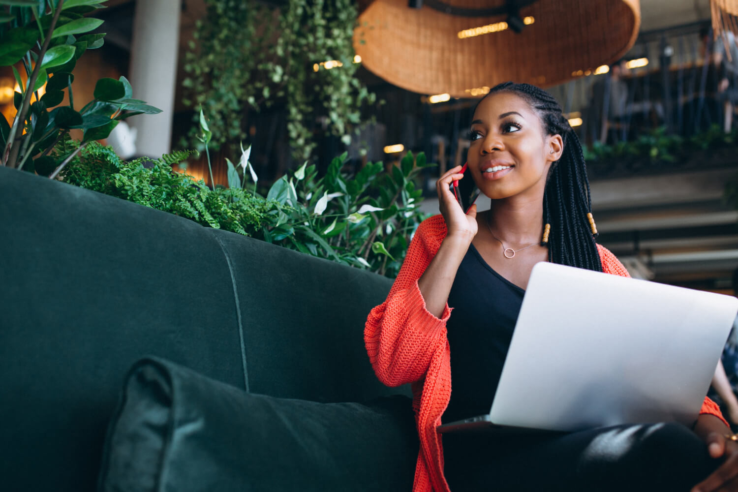 Female CEO of a small business working on her laptop while on a call