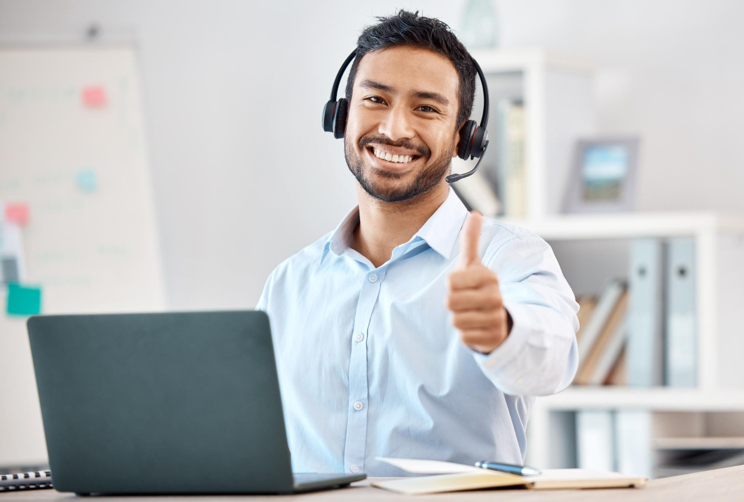 Man in his office doing a thumbs up