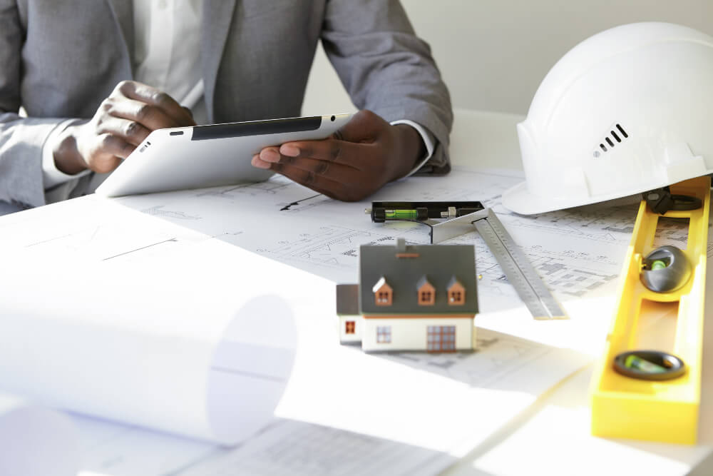 A construction engineer using a construction payroll software on their touch pad